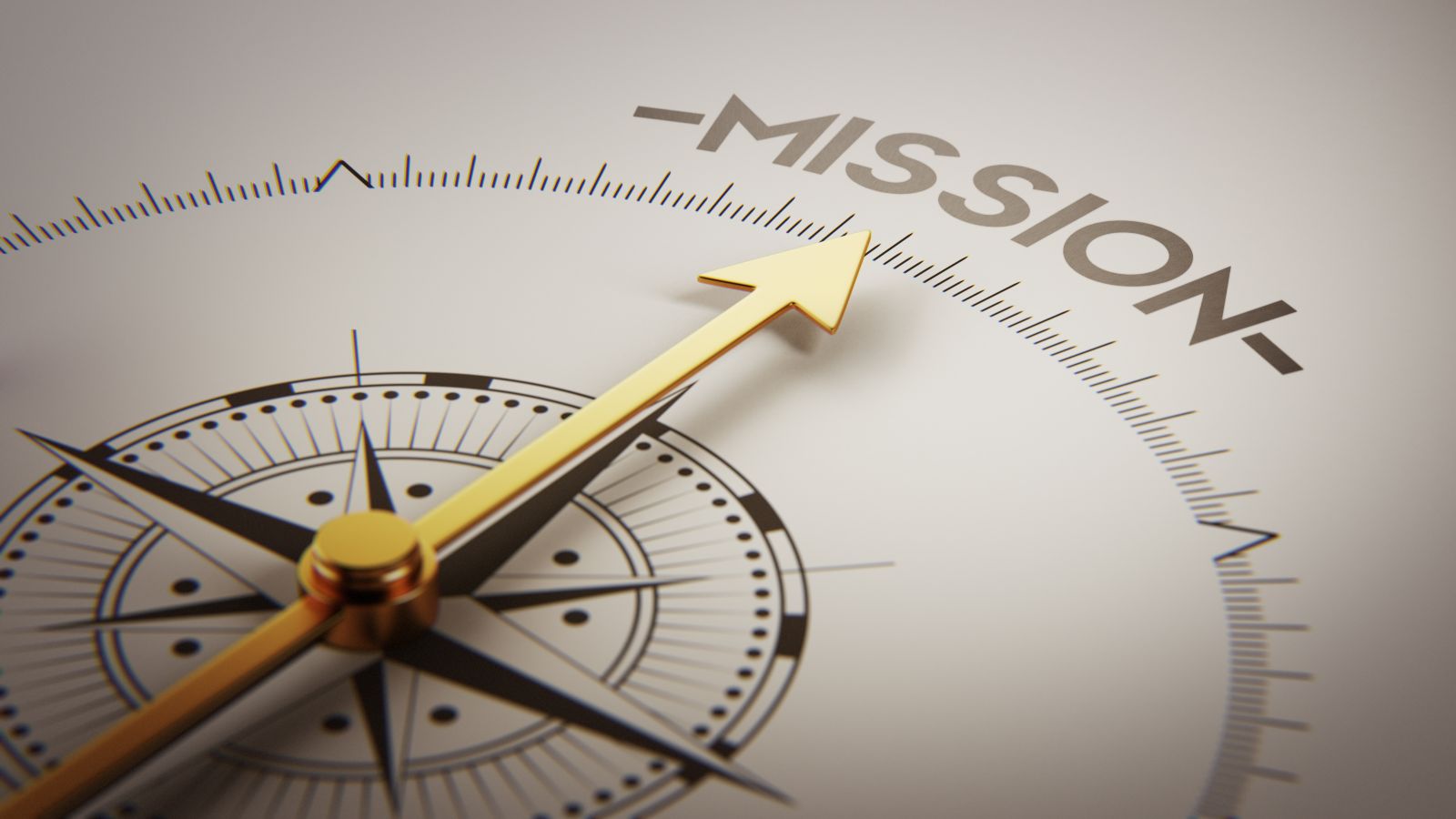 Kompass mit goldener Nadel zeigt auf das Wort Missionen